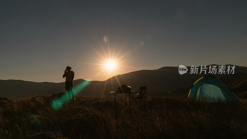 Adult Man Looking At The View While Camping In Sunset